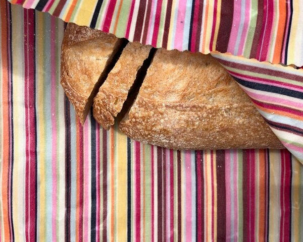 Loaf of bread on a colorful striped fabric background