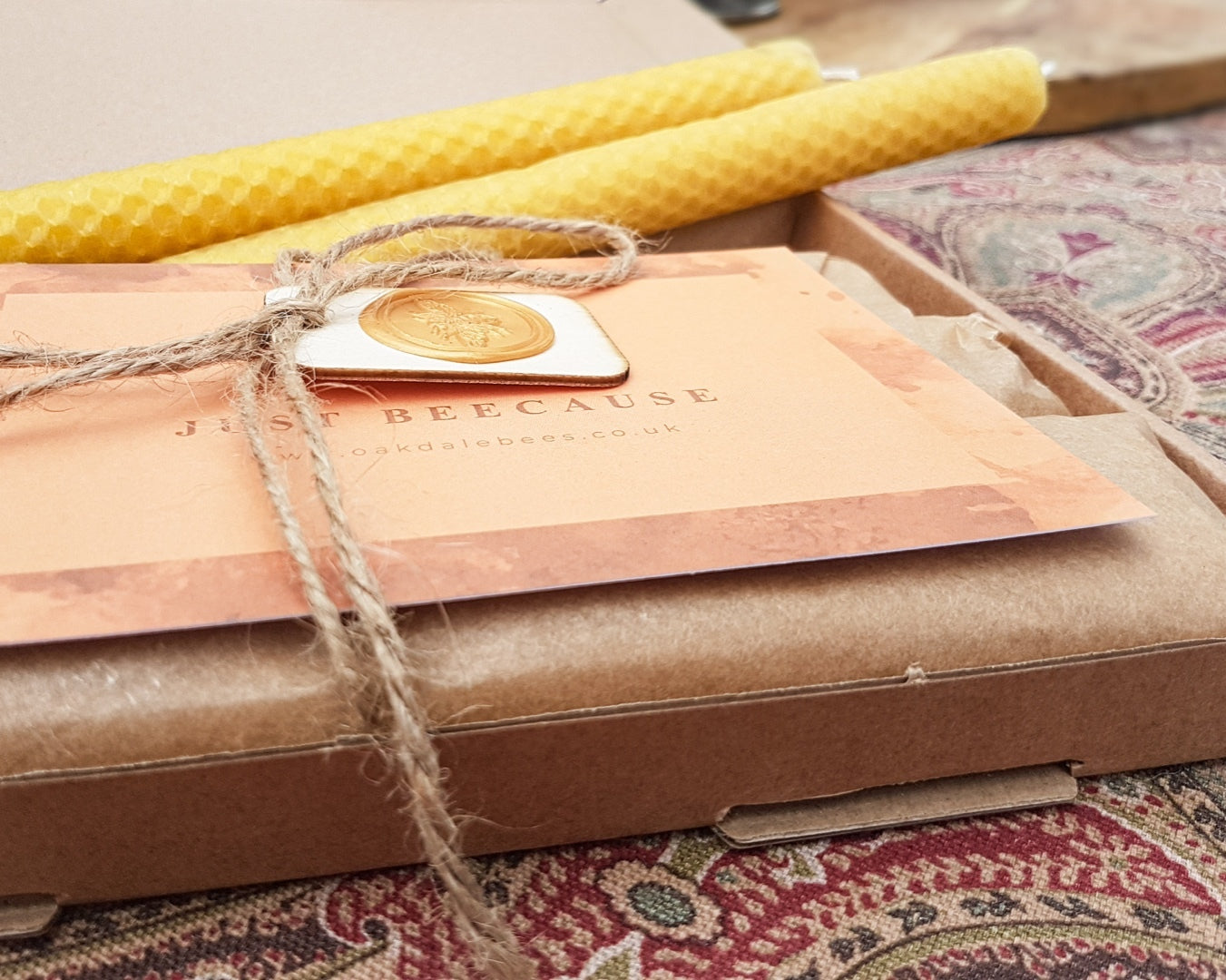 Gift box with a card and decorative elements on a patterned surface