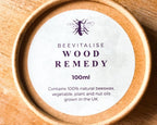 Beevitalise Wood Remedy container on a wooden surface