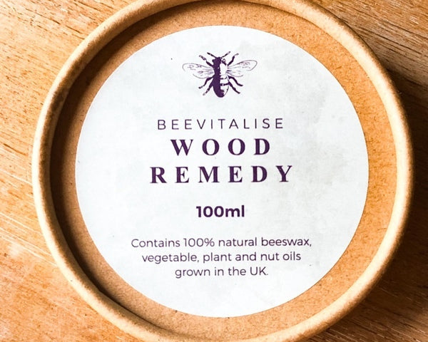 Beevitalise Wood Remedy container on a wooden surface