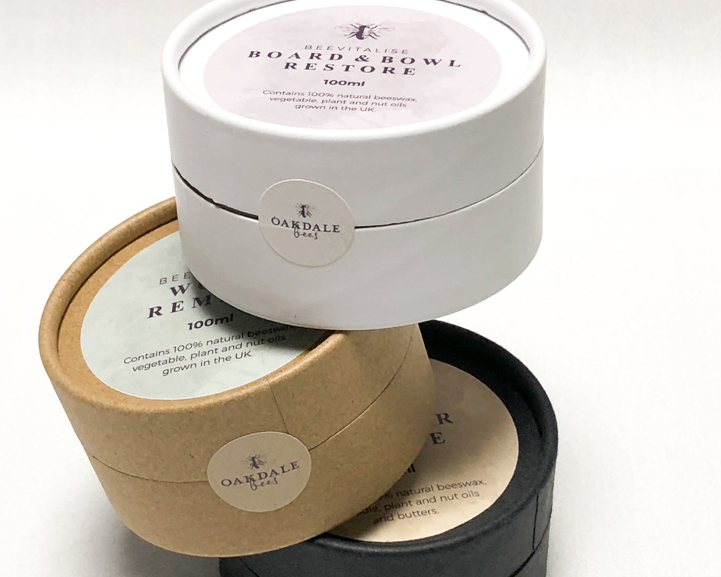 Three circular containers with lids, each labeled 'Oakesdale', on a white background.